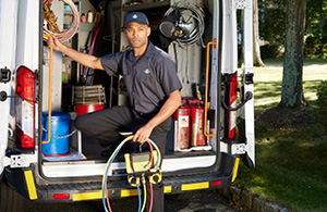 Service tech standing in front of van