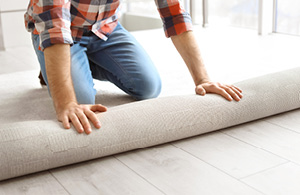 Person installing carpet